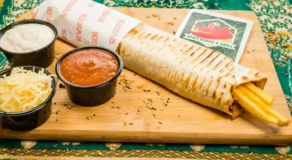 Syty wrap z kurczakiem i frytkami, sosy i ser. Pyszny posiłek, który może mieć około 100g kurczaka kcal.